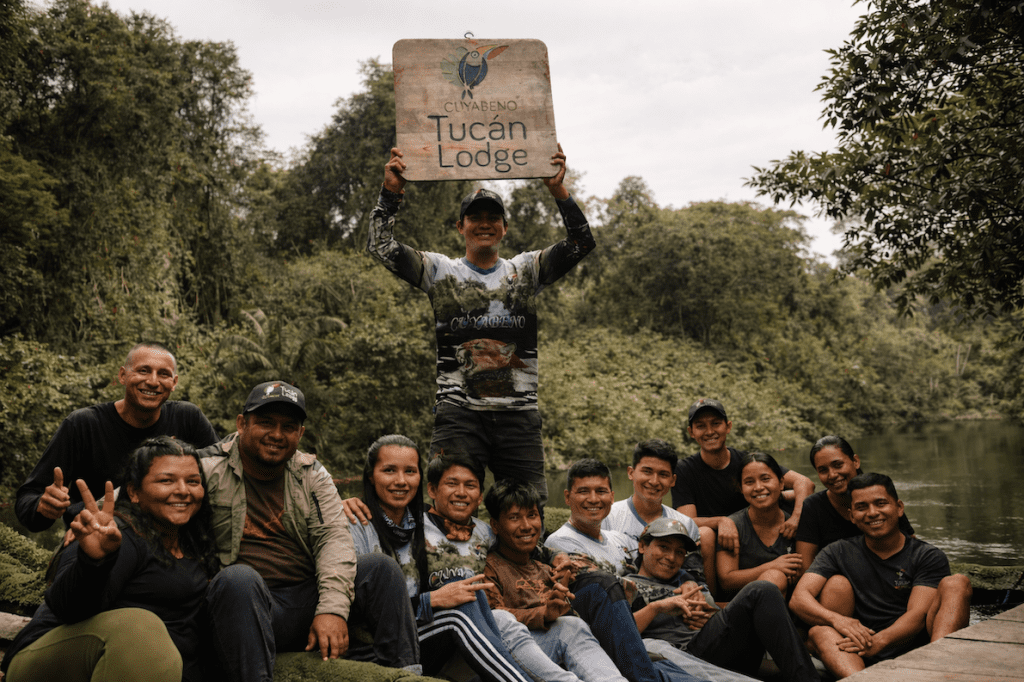Team of local guides and staff at Cuyabeno Tucán Lodge standing together in the Amazon rainforest